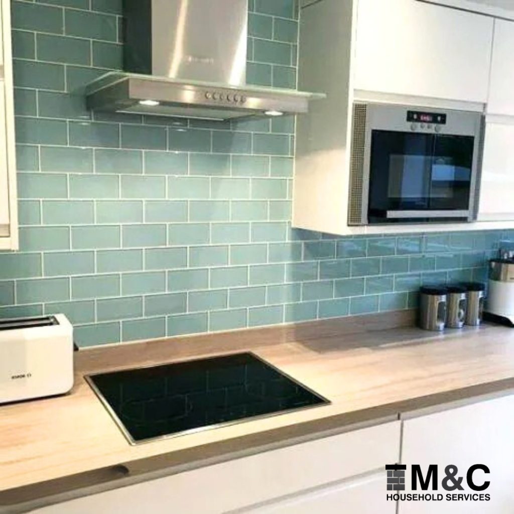 Freshly tiled kitchen backsplash in Welwyn home by M&C